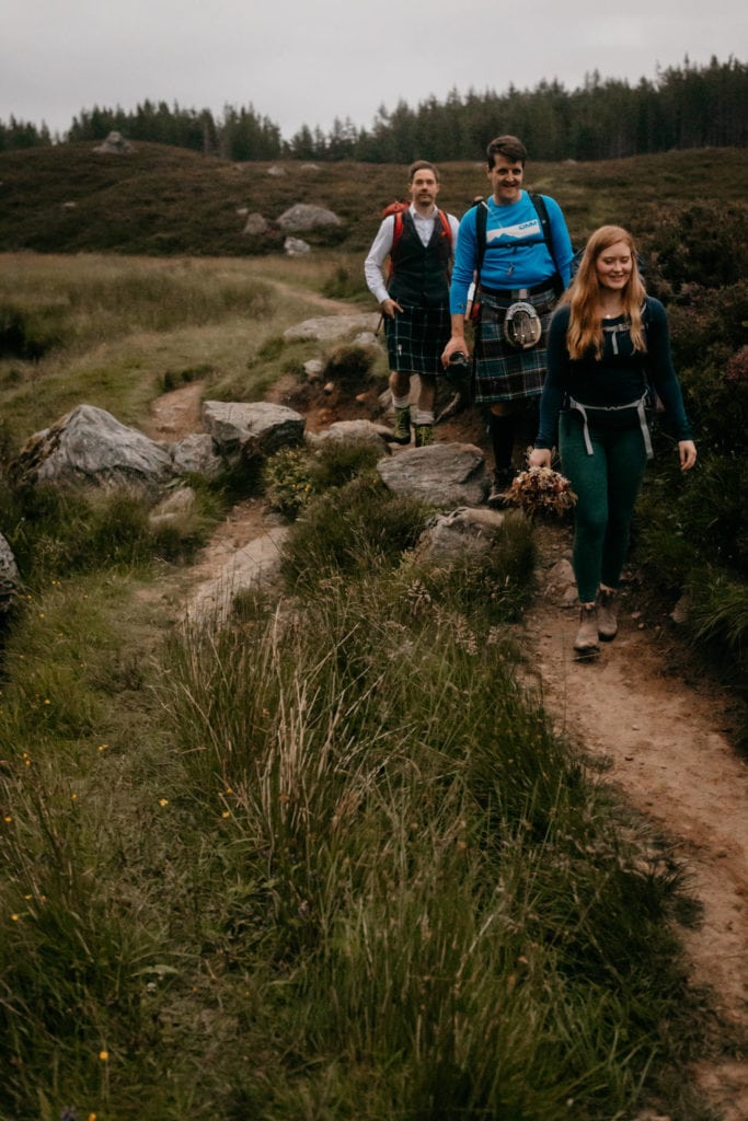 Couple with their celebrant hiking out in the Caingorms on their elopement Couple with celebrant hiking out in the Caingorms on their elopement