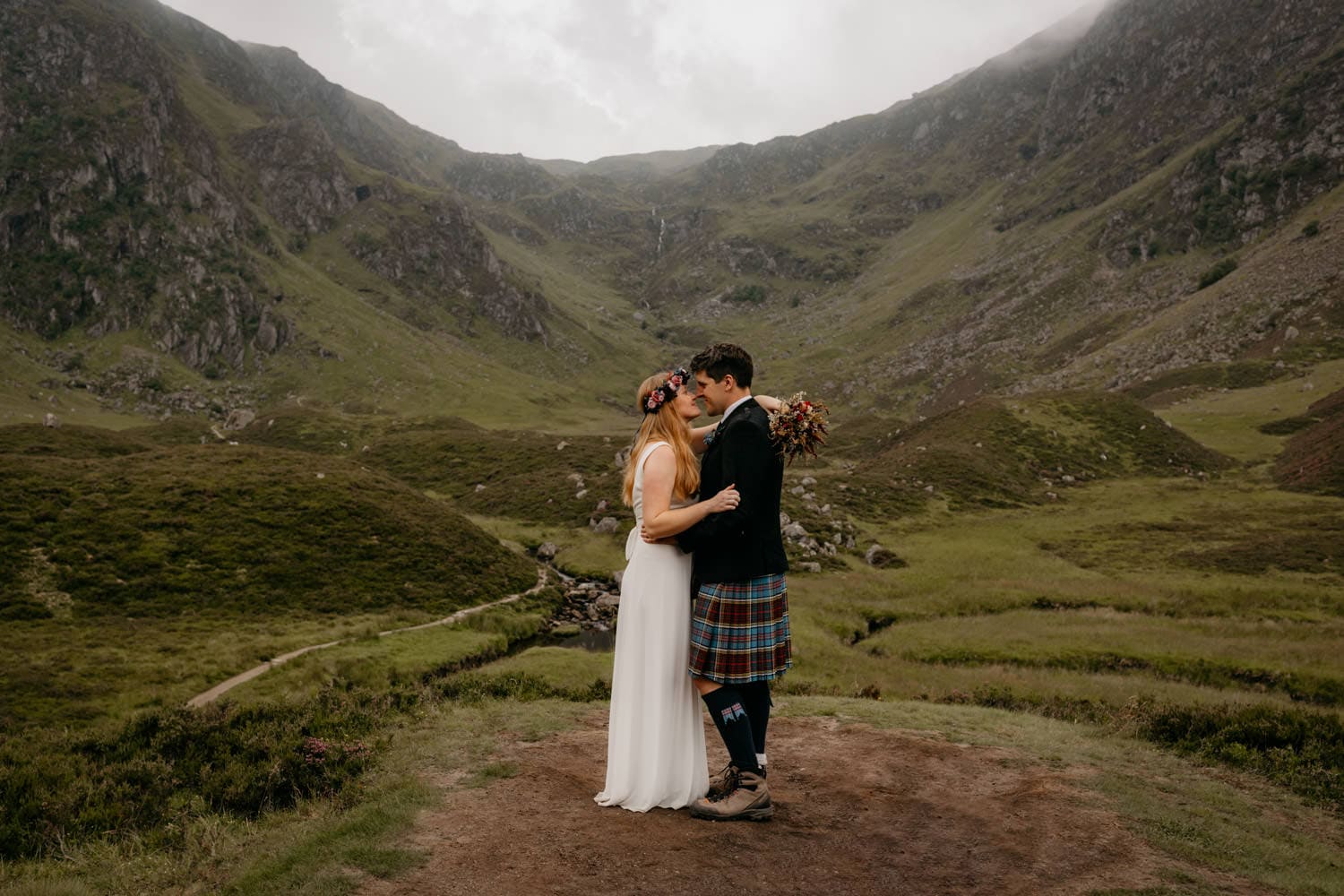 Couple embracing during their elopemnt at Corrie Fee, Cairngorms, Scotland