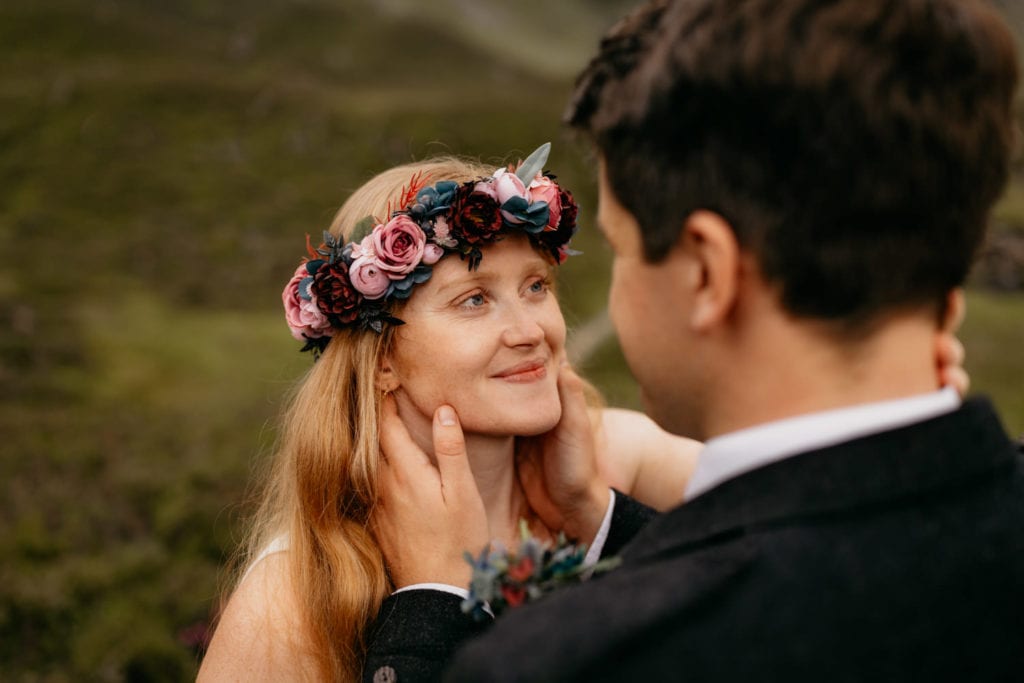 Boho bride gazes into the eyes of her new husband in the Caingorms