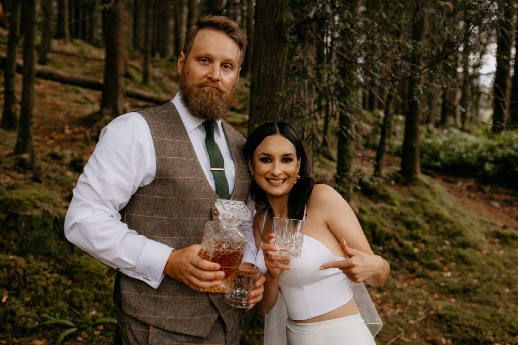 Eloping couple with whisky glencoe lochan