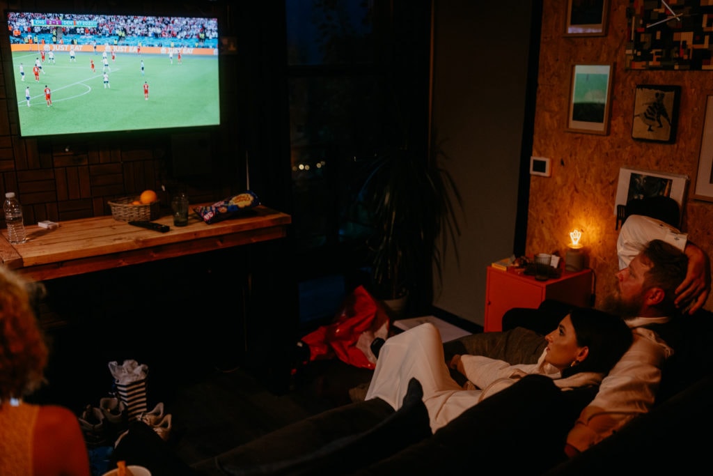 Elopement couple watching football match