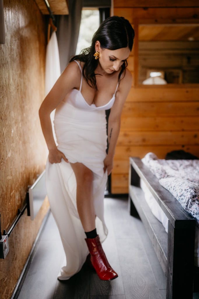 Bride putting on red boots