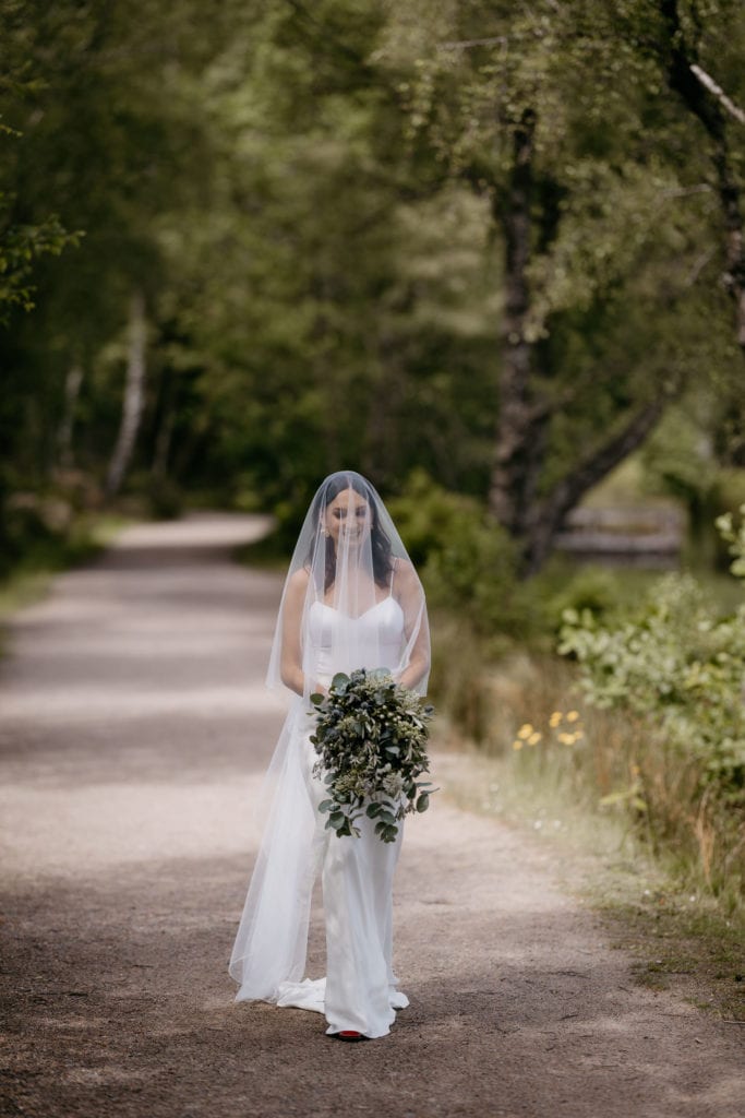 Bride walking to ceremony Glencoe Lochan