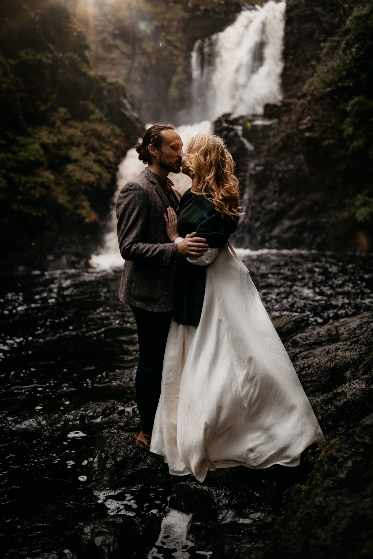 Couple kissing by waterfall on Isle of Skye 