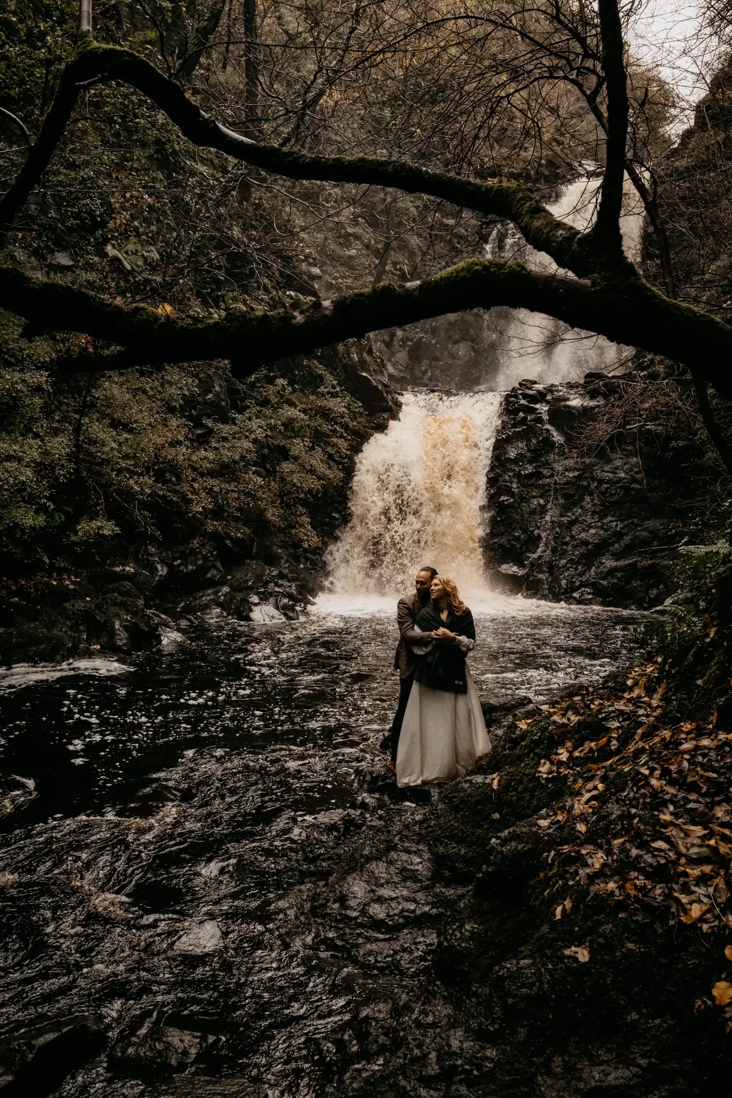 Engaged couple by waterfall on Isle of Skye 