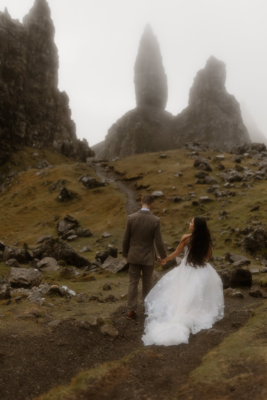 Wedding couple walking at Old Man of Storr, Isle of Skye