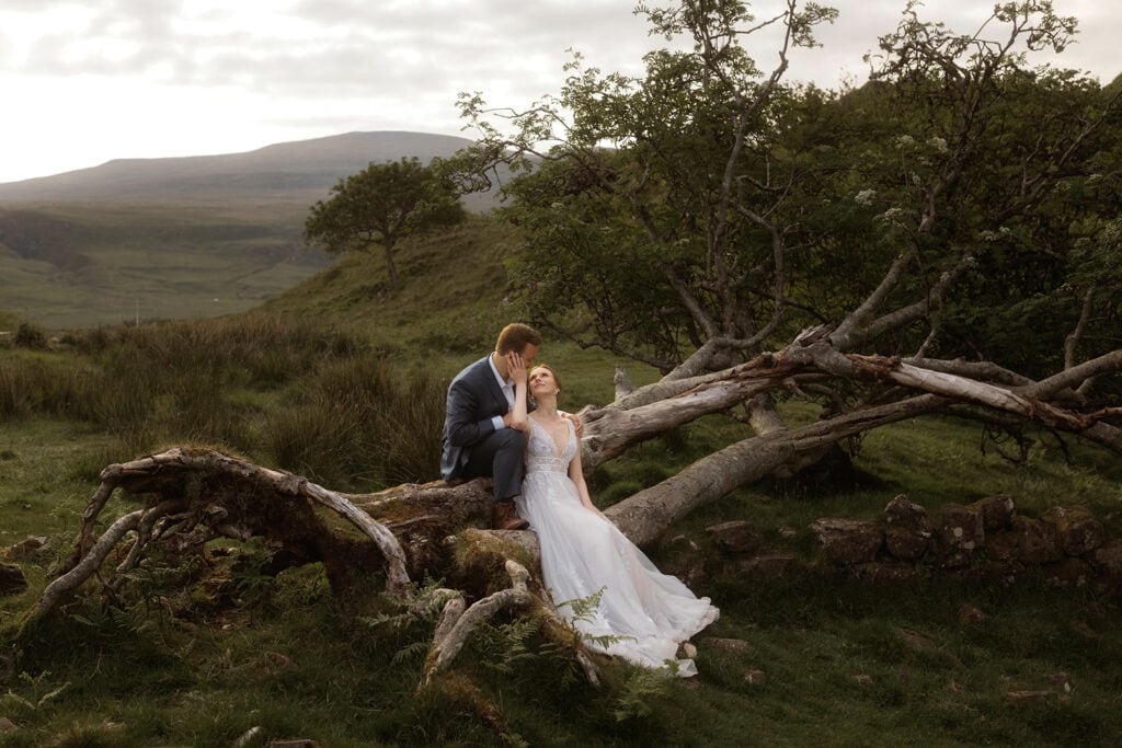 Celeste and Doug share an intimate moment at Fairy Glen, Isle of Skye while perched atop a branch of a tree