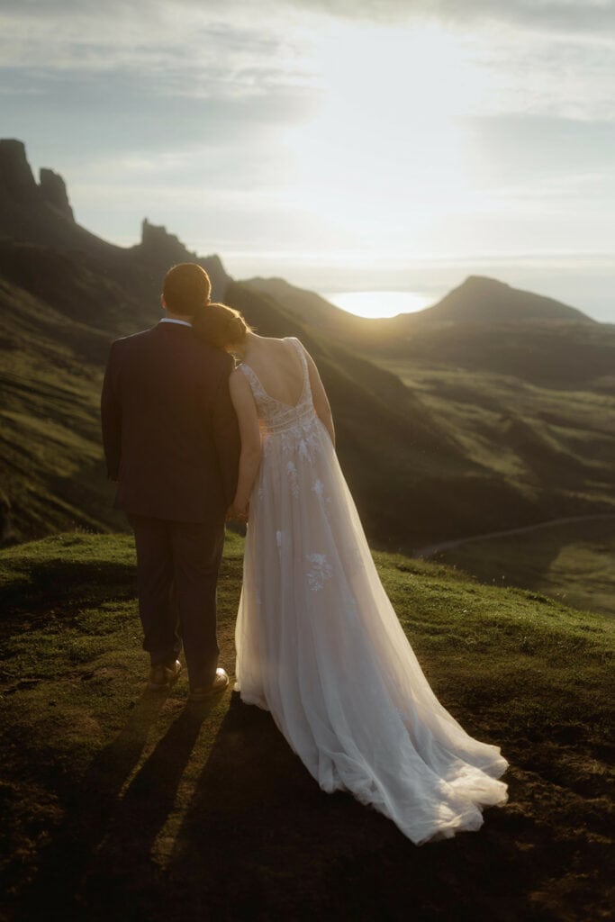 Celeste and Doug watch the sunrise together behind the beautiful mountains of Quiraing on the Isle of Skye for their Scotland Post-Wedding photo session.