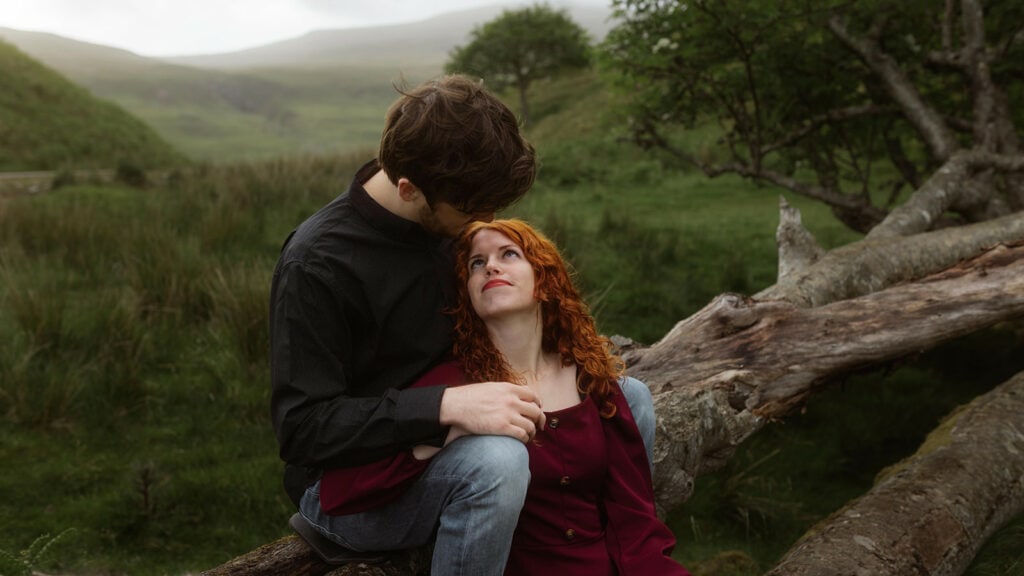 Ashley and Bobby share an intimate moment at Fairy Glen, Isle of Skye while perched atop a branch of a tree