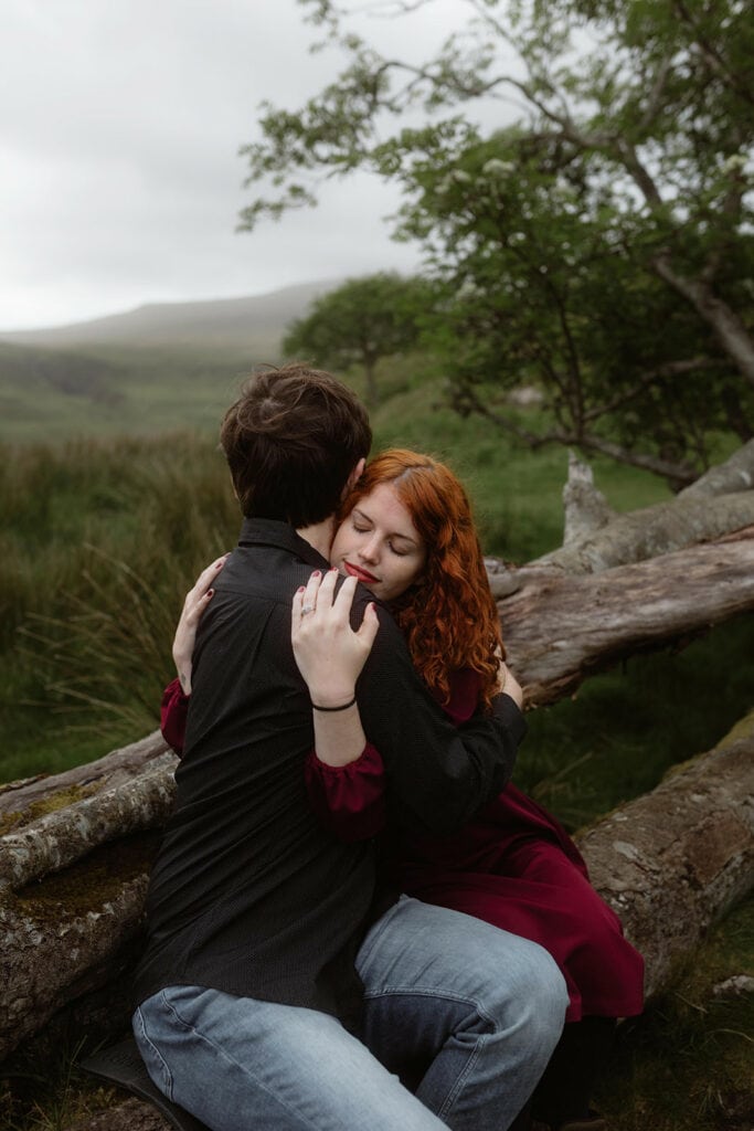 Ashley and Bobby share an intimate moment at Fairy Glen, Isle of Skye while perched atop a branch of a tree