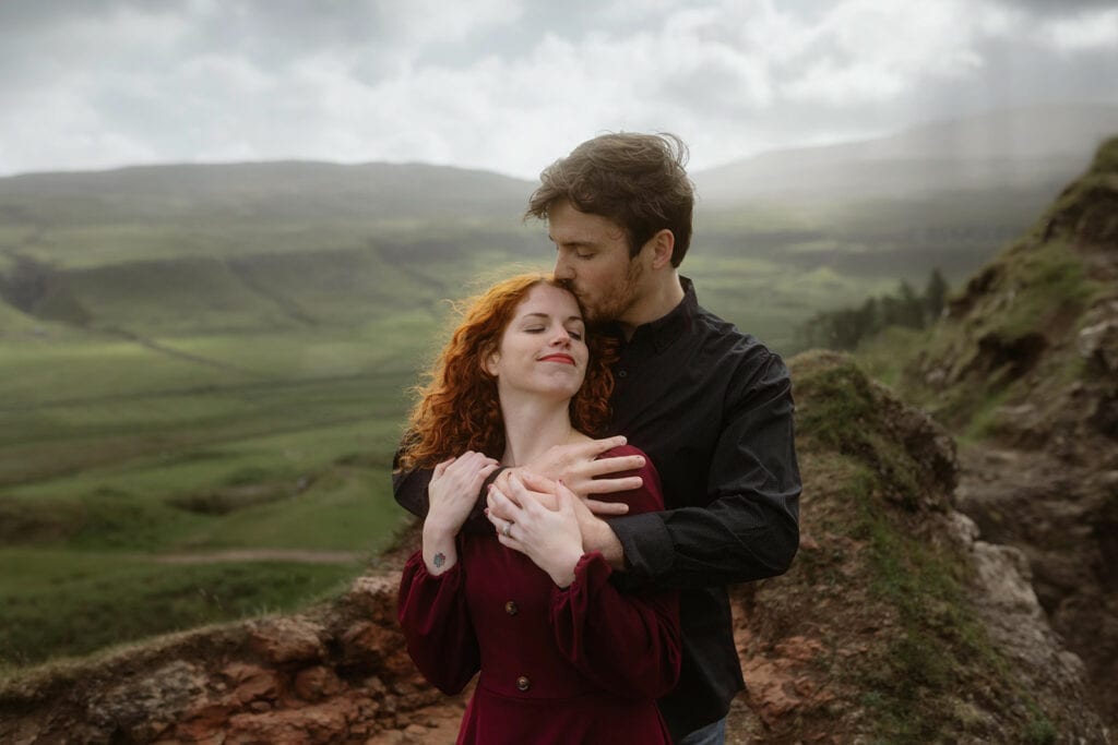 Ashley and Bobby share a beautiful moment as they smile brightly in the Isle of Skye, enjoying the breathtaking scenery and their special time together.